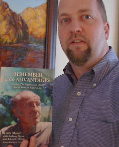 Anthony Wynn, holding the book "Remember with Advantages".